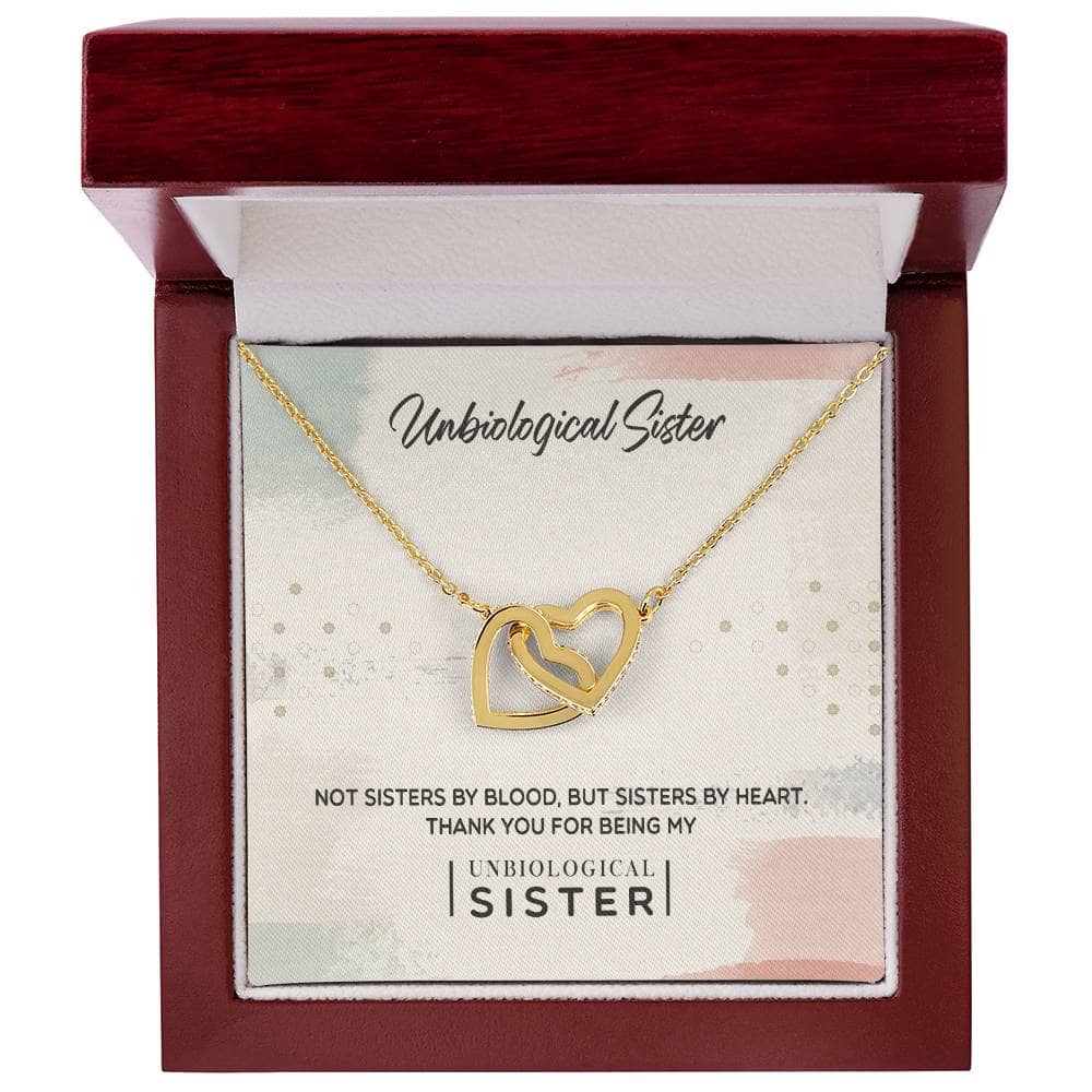 Alt text: "Customized Unbiological Sisters Heart-Link Necklace in a box, adorned with gold finish and cubic zirconia, symbolizing sisterly love and connection."
