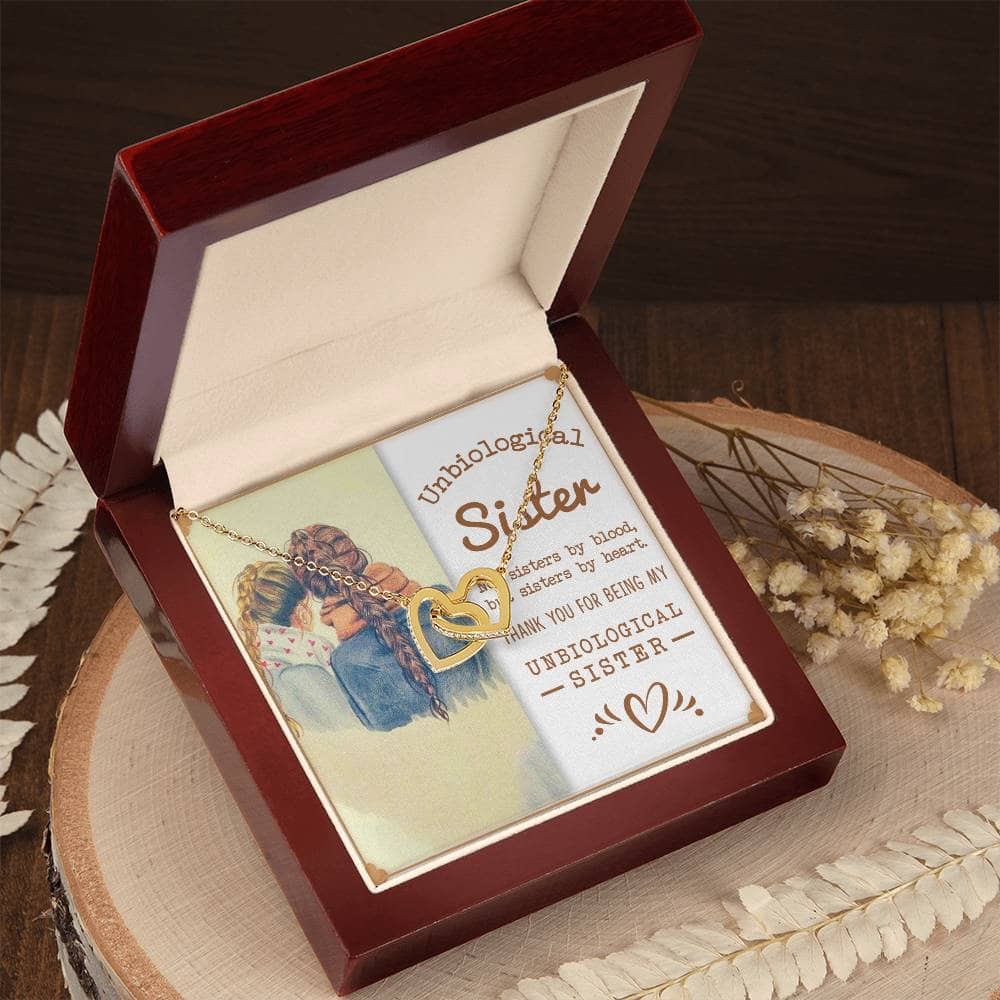 Alt text: "Customized Unbiological Sisters Interlocking Hearts Necklace in a box"