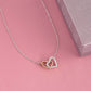 A heart-shaped necklace on a chain, adorned with interlocking hearts or a love knot pendant, symbolizing the bond between unbiological sisters.