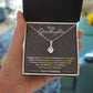 A hand holding an Elegant Personalized Granddaughter Necklace with Heart Pendant in a box.