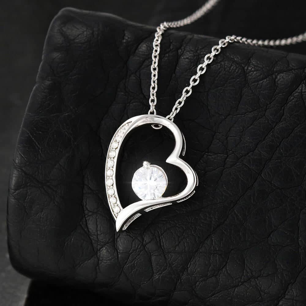 A silver heart necklace with a diamond in the middle, perfect for commemorating your love. The pendant signifies the luminous sparkle of your special moments together. Crafted with lasting durability and aesthetic value, this necklace set is a remarkable gift for your wife. Comes in a luxurious box for gifting.