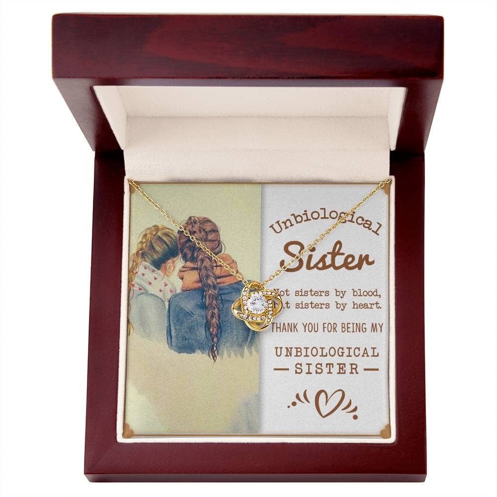 Alt text: "Entwined Hearts Charm necklace featuring two girls and a necklace in a box, symbolizing the bond of unbiological sisters."