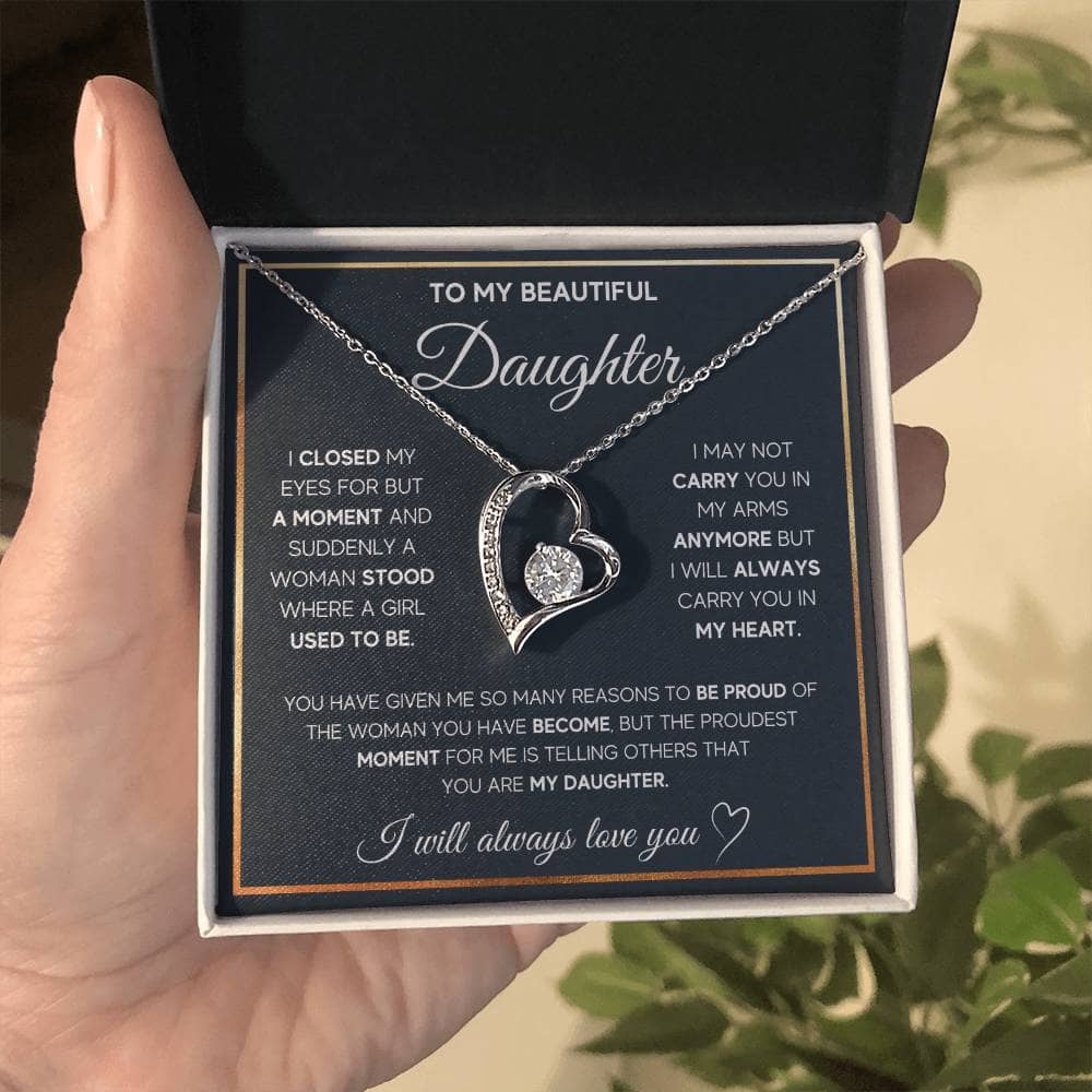 Alt text: "Hand holding Eternal Bond Personalized Daughter Necklace in a box, featuring heart-shaped pendant. Symbol of endless love and unbreakable bond."
