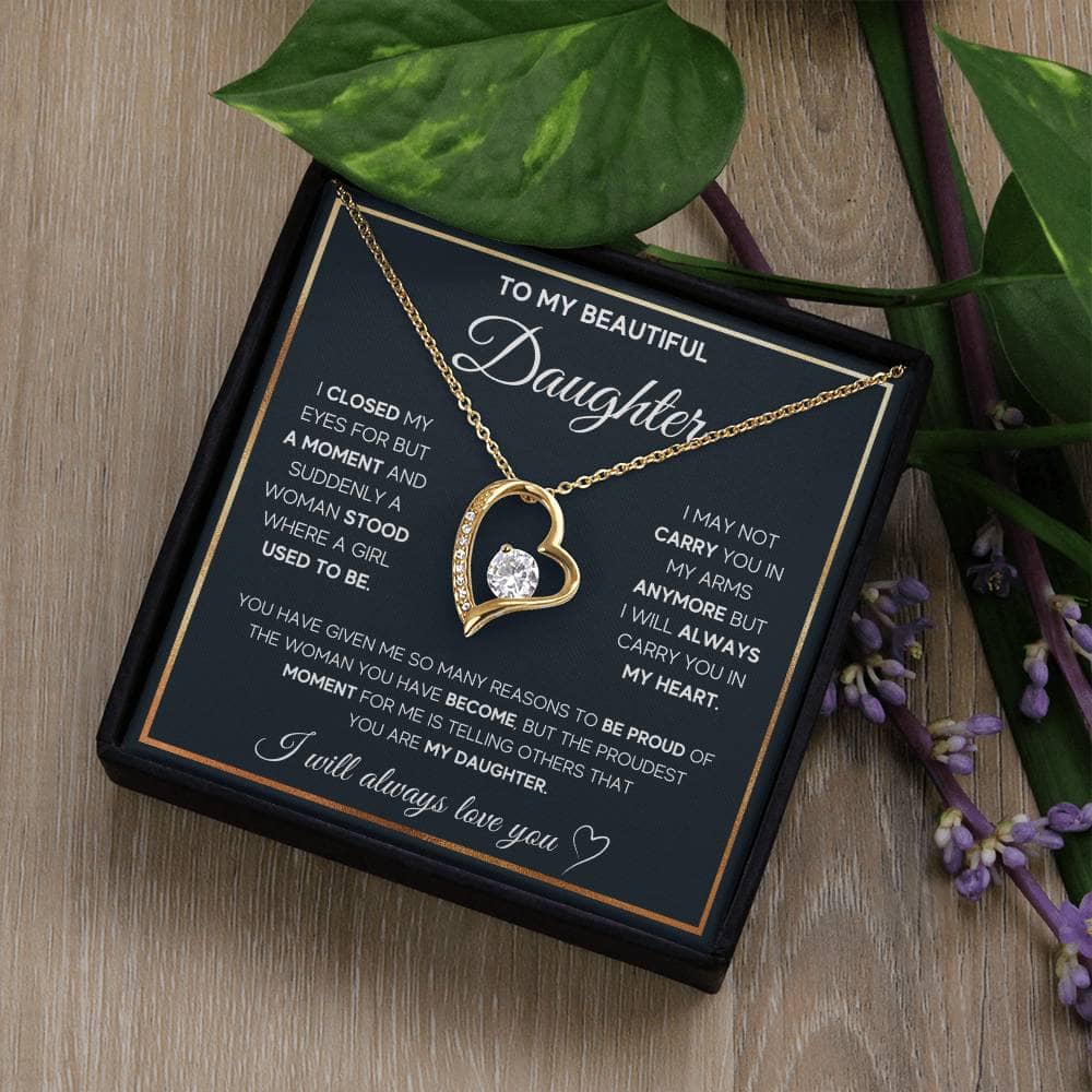 Alt text: "Eternal Bond Personalized Daughter Necklace - Heart-shaped pendant in a box next to a plant"
