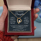 Alt text: "A hand holding the Eternal Bond Personalized Daughter Necklace, a heart-shaped pendant with a diamond in the middle, symbolizing endless love."