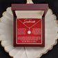 Alt text: "Personalized Soulmate Necklace with cushion-cut cubic zirconia pendant in a red box on a plate"