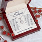 Alt text: "Eternal Hope Necklace: Heart-shaped pendant with red berries and a note in a box, symbolizing enduring love and personalized connection."