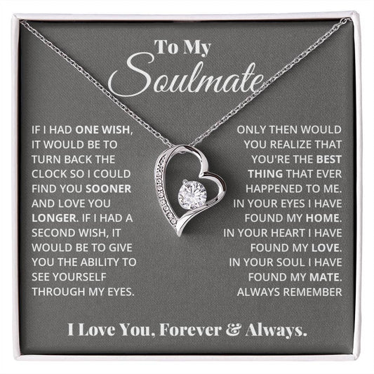 Alt text: "Forever Love Necklace - a heart pendant with a sparkling 6.5mm CZ crystal, adorned with tiny crystals, in a box"