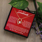 Alt text: "Forever Love Necklace - a necklace in a box next to a plant, symbolizing enduring love and commitment"