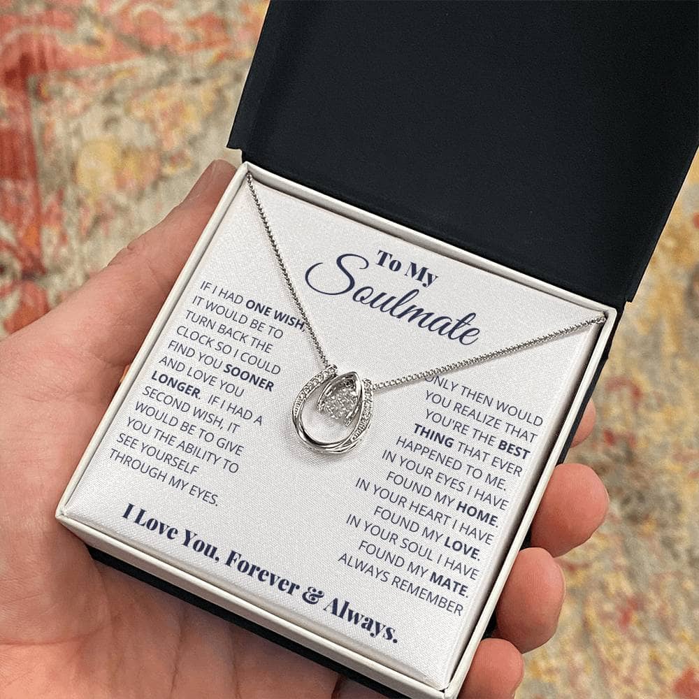 Alt text: "A hand holding a personalized Soulmate Necklace in a box, symbolizing eternal love and deep connection. Made with 14k white gold or 18k gold, adorned with cushion-cut cubic zirconia. Adjustable cable or box-chain for a perfect fit. Luxuriously packaged in a mahogany-style box with LED lighting."