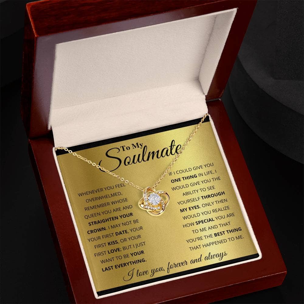 A gold necklace in a box, featuring a diamond pendant, symbolizing eternal connection and love.