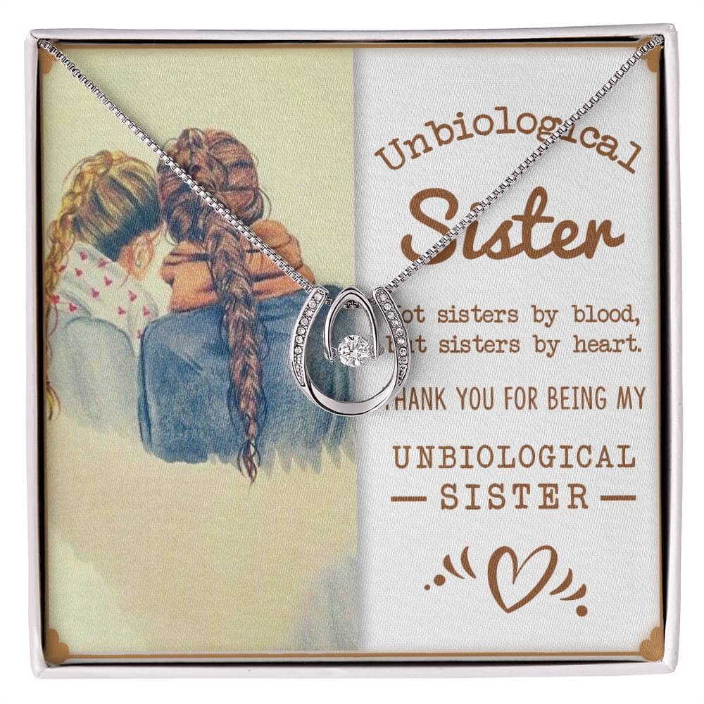 Alt text: "Personalized Unbiological Sisters Necklace - Two women hugging pendant with cubic zirconia, available in white gold or gold finish."