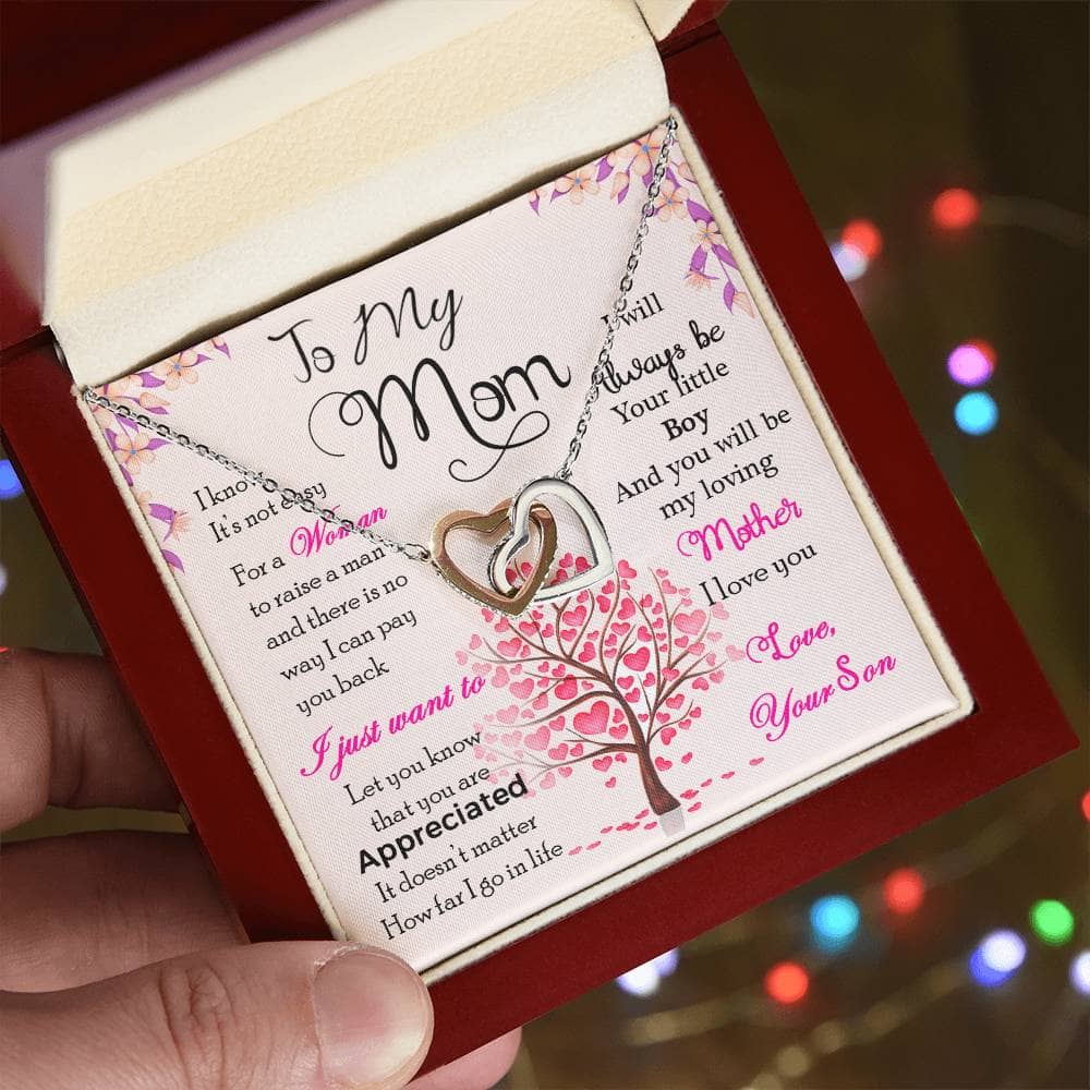 Alt text: "A hand holding a high-quality personalized mother necklace with cushion-cut cubic zirconia pendant, symbolizing the everlasting bond between a mother and her child."