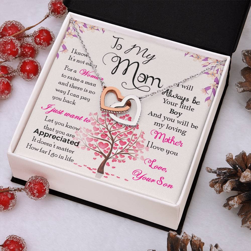 Alt text: "Personalized Mother Necklace in box with pine cones and berries"