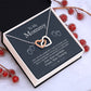 Alt text: "Interlocking Hearts Necklace - A necklace in a box, featuring two heart-shaped pendants adorned with cubic zirconia crystals. Symbolizing the eternal love between a mother and child. Perfect personalized mother necklace gift from child."