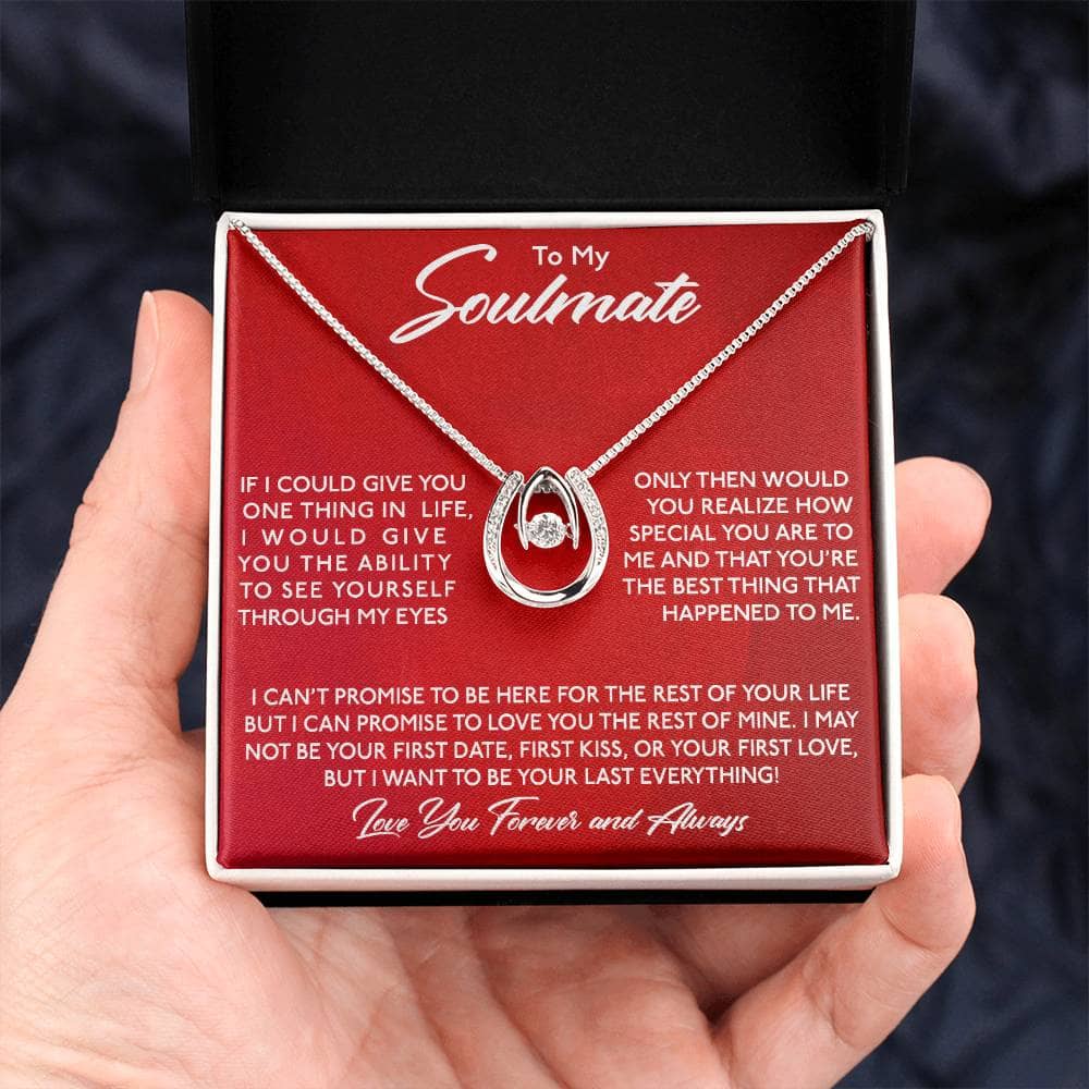A hand holding a Lucky in Love Necklace in a box, symbolizing everlasting love and commitment.