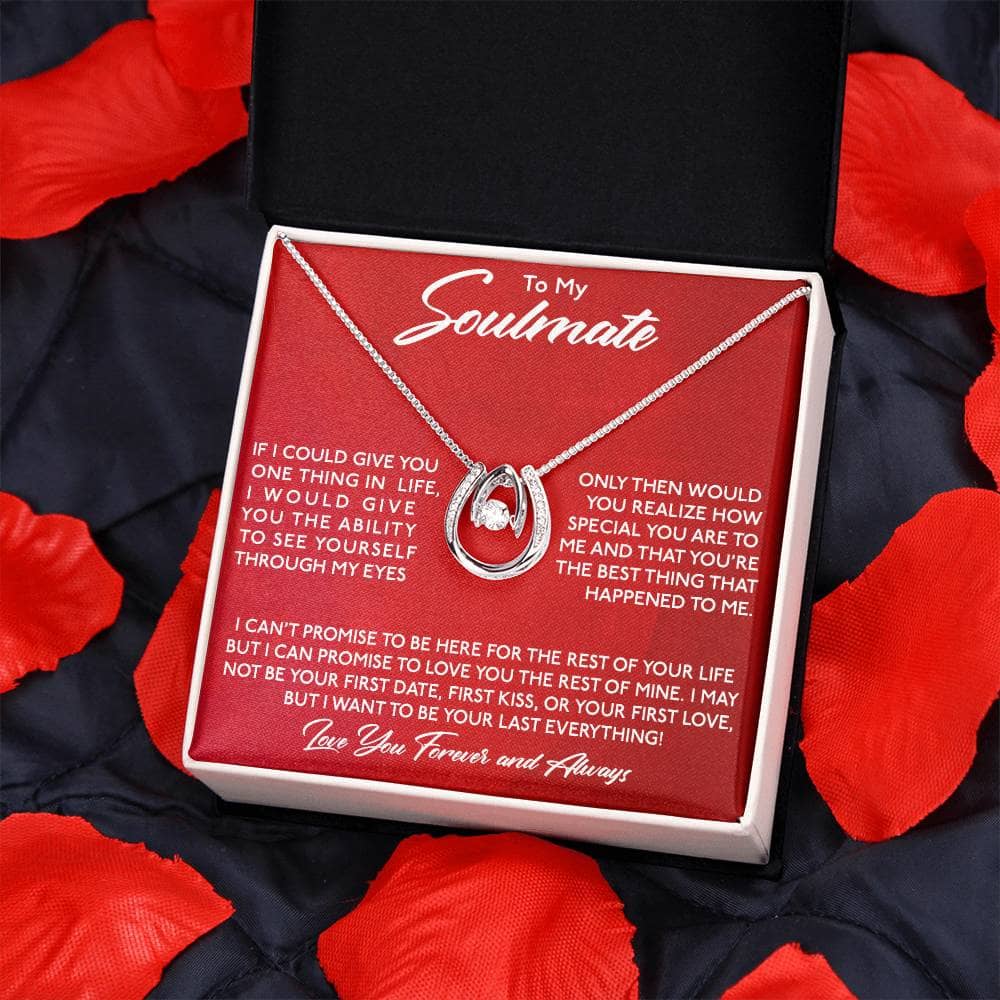 Alt text: "Lucky in Love Necklace - a personalized necklace in a box, symbolizing everlasting love and commitment, presented on a blanket"