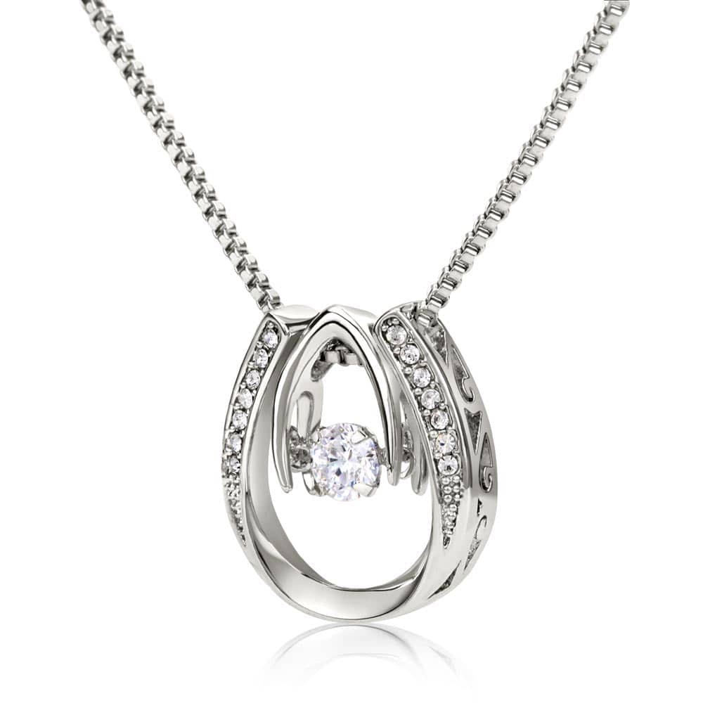A silver necklace with a diamond in the center, symbolizing everlasting love and commitment.