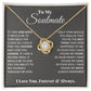 A close-up of the My Love Discovered in Your Heart - Soulmate Love Knot Necklace, a necklace in a box. The necklace features a cushion-cut cubic zirconia pendant set in luxurious 14k white gold or 18k gold, symbolizing the bond of soulmates.