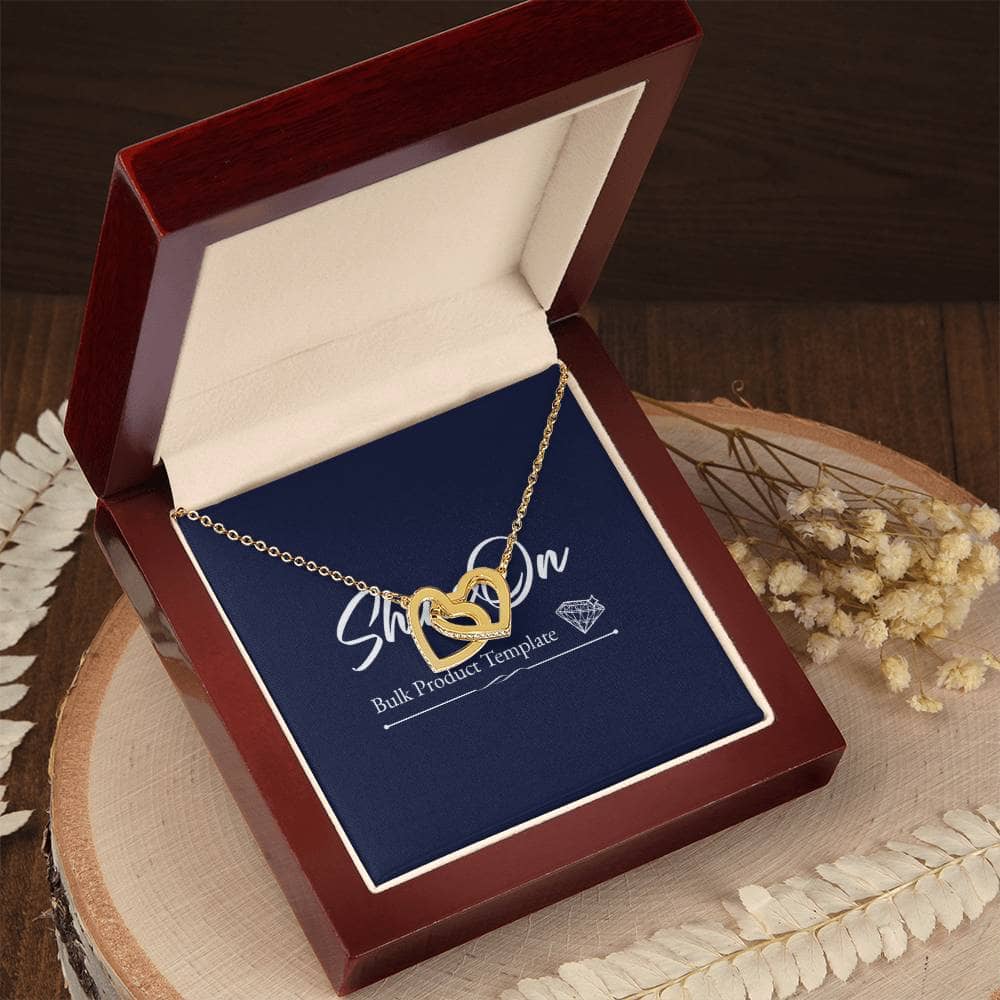 A gold necklace with two interlocking hearts embellished with CZ crystals, perfect for gifting. Pendant dimensions: 0.6" height / 1.1" width. Adjustable length: 18" - 22". Lobster clasp. Packaged in a soft touch box.