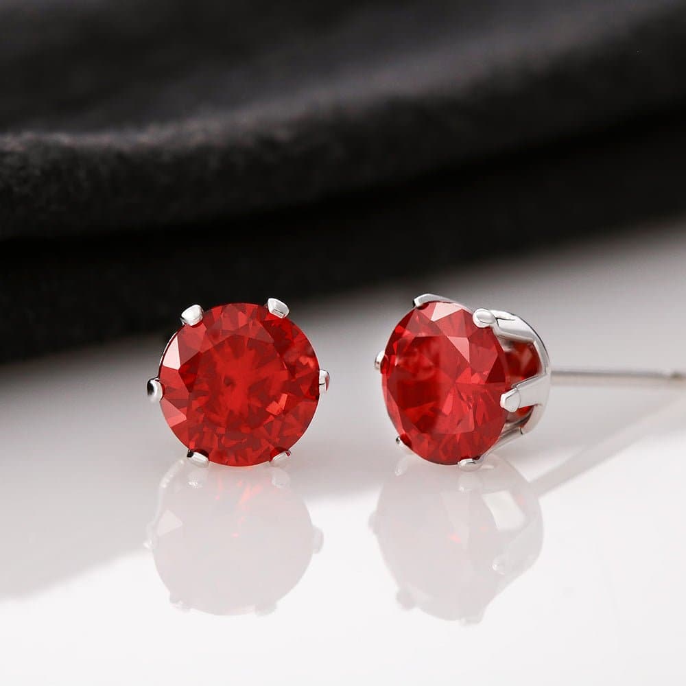 A pair of red gemstone earrings with 14K white gold dipped settings & post.