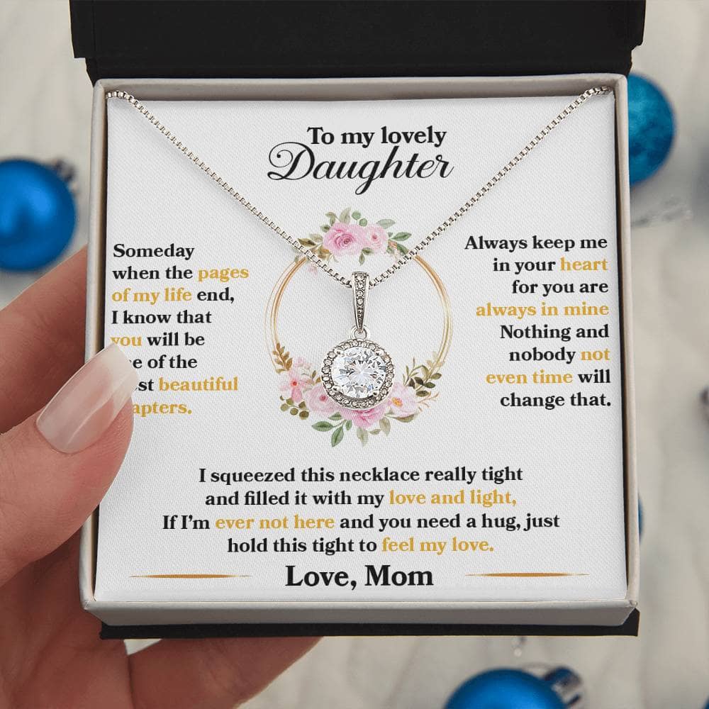 A hand holding a Personalized Daughter Necklace in a box, symbolizing an unbreakable bond and eternal love.