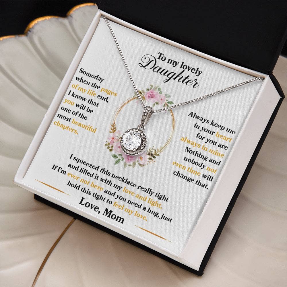 A close-up image of the Personalized Daughter Necklace in a box. The necklace features a silver heart-shaped pendant with a cushion-cut cubic zirconia. The necklace comes with an adjustable chain and arrives in a luxurious mahogany-style box with LED lighting. Celebrate the unbreakable bond between parents and daughters with this elegant and meaningful token of love.