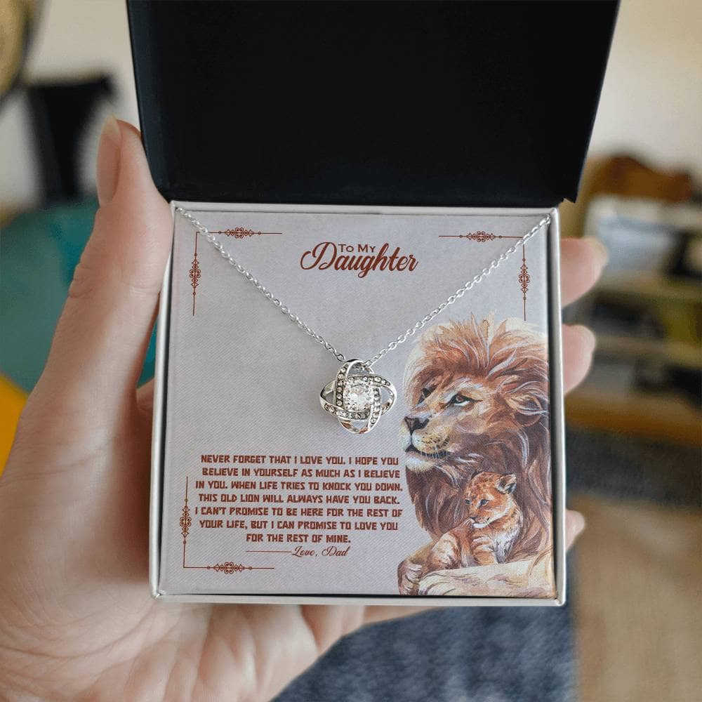 Alt text: "A hand holding a personalized daughter necklace in an elegant box with LED lights."