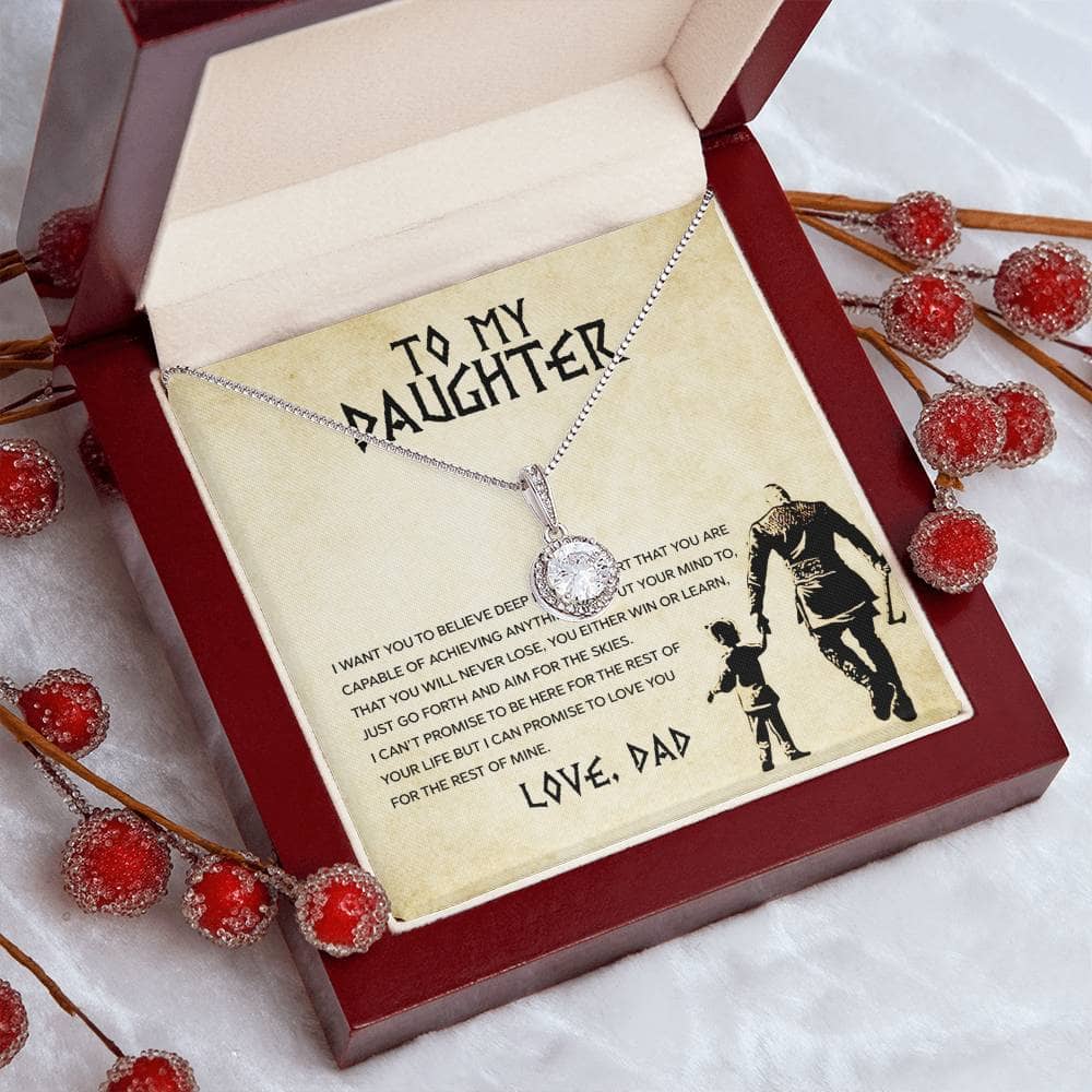 A necklace in a box with a picture of a child and a drawing of a father, representing the unbreakable bond between parent and daughter.