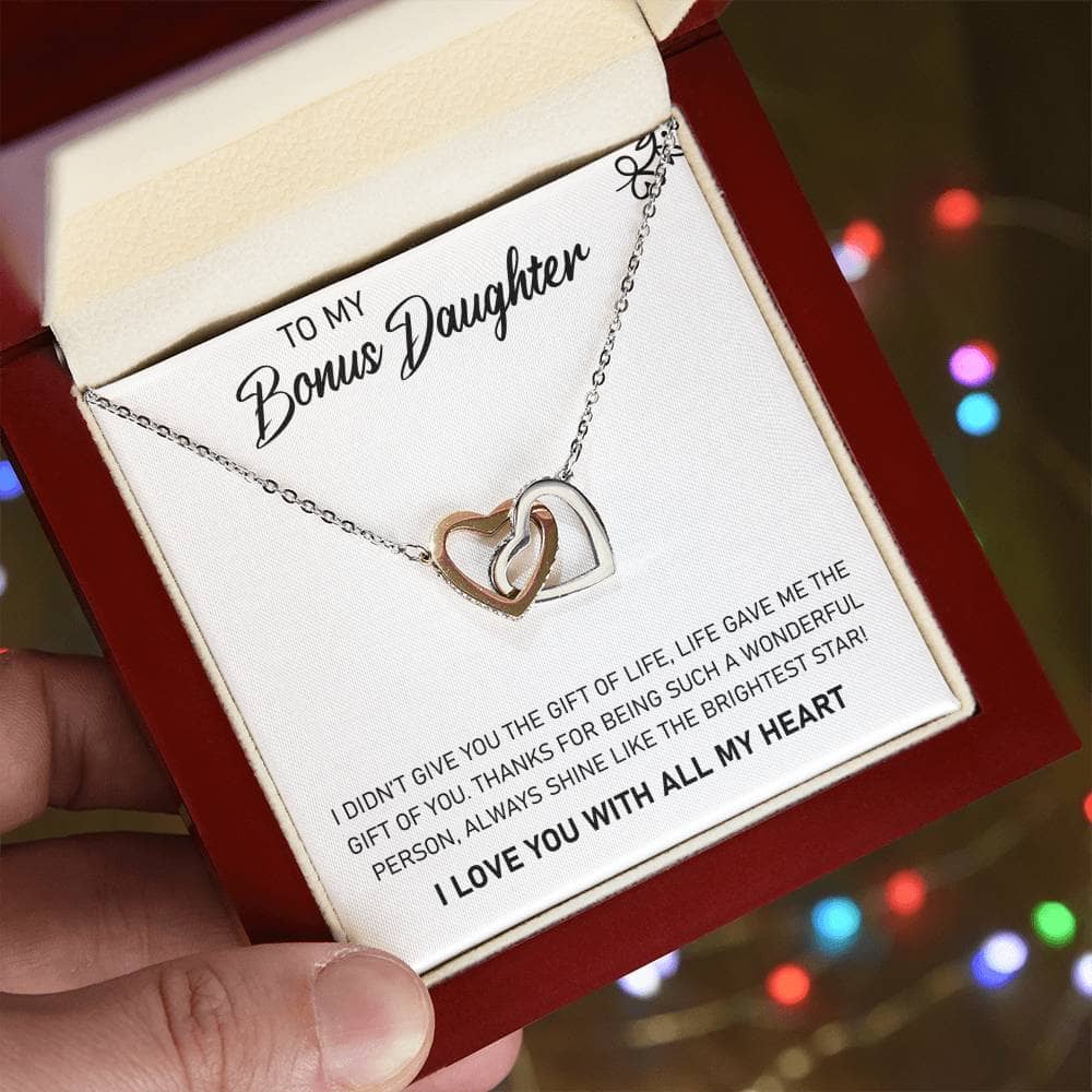 A hand holding the elegant Personalized Daughter Necklace, adorned with a heart-shaped pendant and cubic zirconia, symbolizing the enduring bond between parent and daughter.