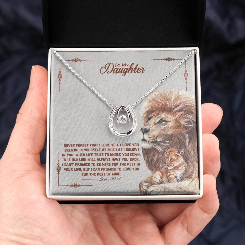 Alt text: "A hand holding a Personalised Daughter Necklace in a box, symbolizing the enduring bond between parents and daughters."