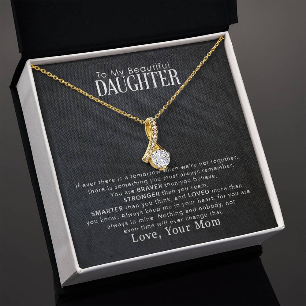Alt text: "Personalized Daughter Necklace: A necklace in a box, featuring a heart-shaped pendant and sparkling cubic zirconia. Symbolizes the enduring bond between parents and daughters. Made with love in the USA."