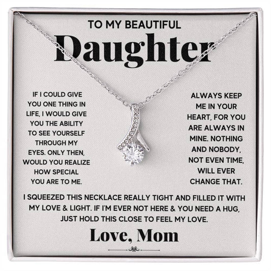 A necklace with a diamond pendant in a box, part of the Personalized Daughter Necklace collection by Bespoke Necklaces.