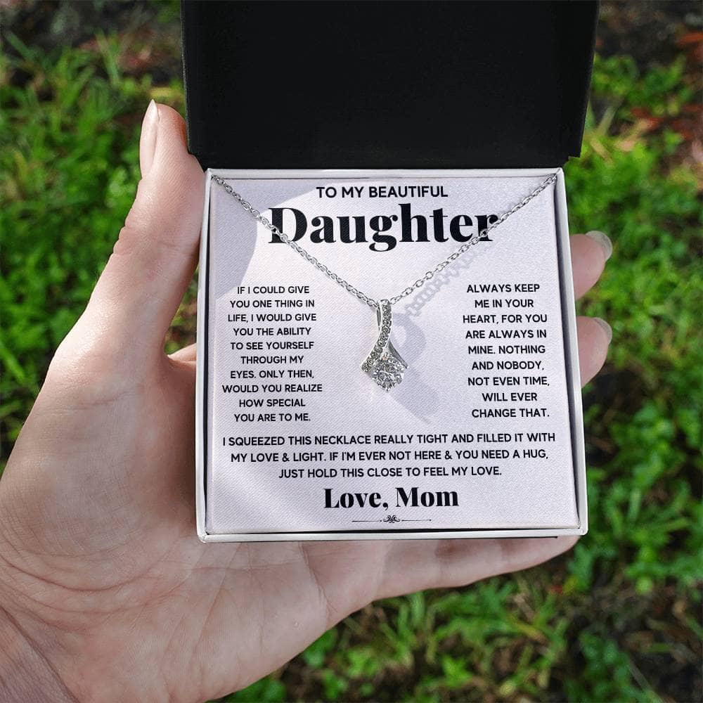 Alt text: "Hand holding Personalized Daughter Necklace in a luxurious box with LED lighting"