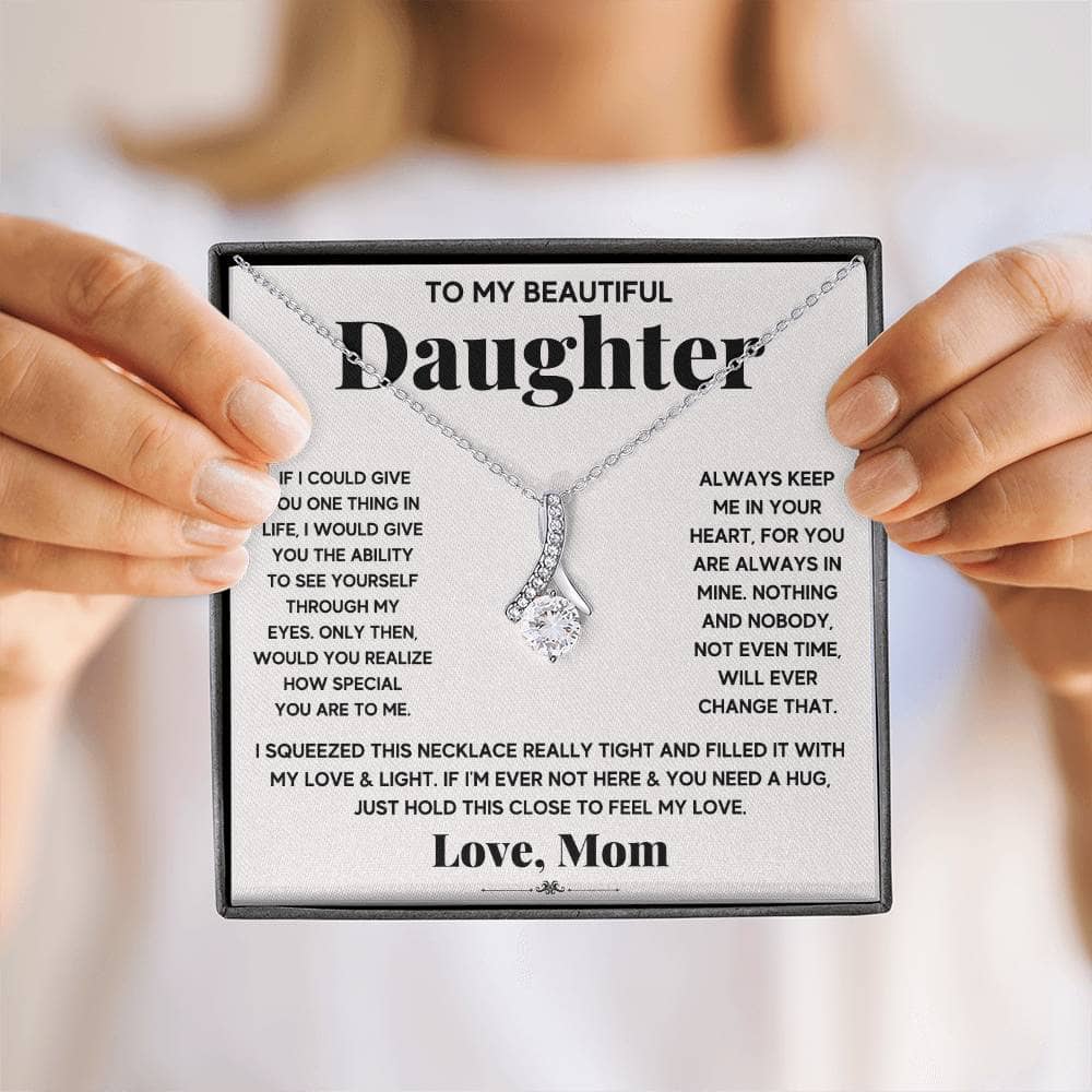 A person holding an elegant Personalized Daughter Necklace, symbolizing the enduring bond between parents and daughters.