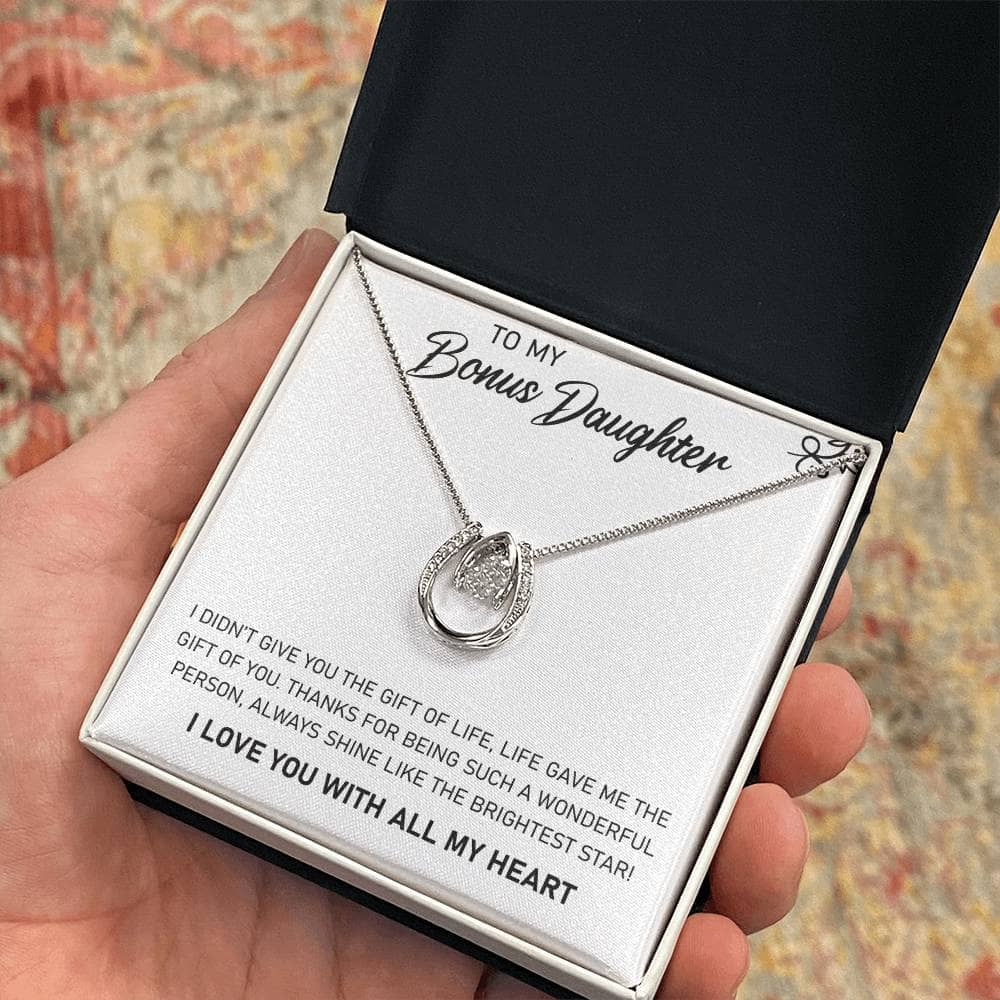 Alt text: "A hand holding a Personalized Daughter Necklace in a box, symbolizing the unbreakable bond between parents and their beloved daughters. Crafted with premium materials and adorned with cushion-cut cubic zirconia, this necklace is a heartfelt tribute to parental love."