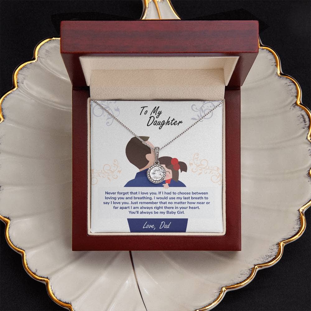 Alt text: "Personalized Daughter Necklace - Eternal Hope: Necklace in a box on a plate, featuring a diamond pendant on a chain and a silver and white pendant close-up."