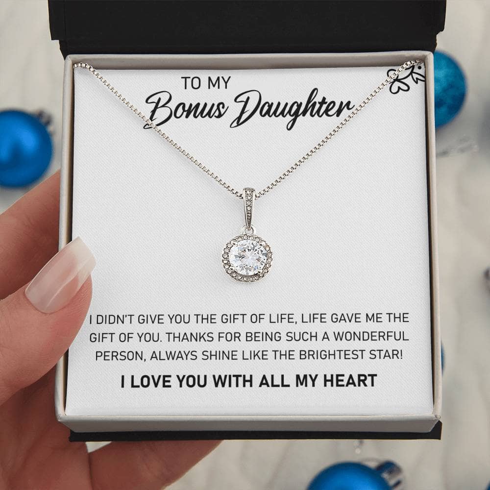 A hand holding a personalized daughter necklace in a box.
