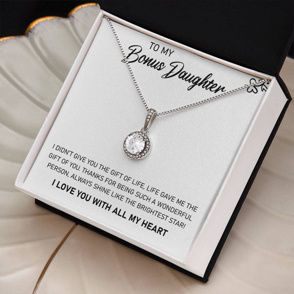A close-up image of a necklace in a box, featuring a heart-shaped pendant with a cushion-cut cubic zirconia. This personalized daughter necklace symbolizes the unending love and bond between a parent and a daughter. The necklace is elegantly designed with high-quality materials and comes in a stunning mahogany-style box with LED lighting for a memorable unboxing experience.