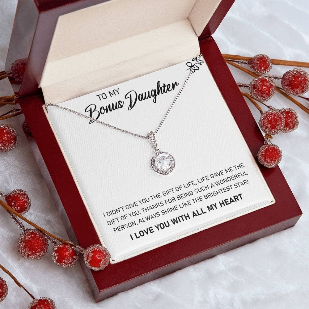 A personalized necklace in a box with red berries, symbolizing the unending love between a parent and a daughter.