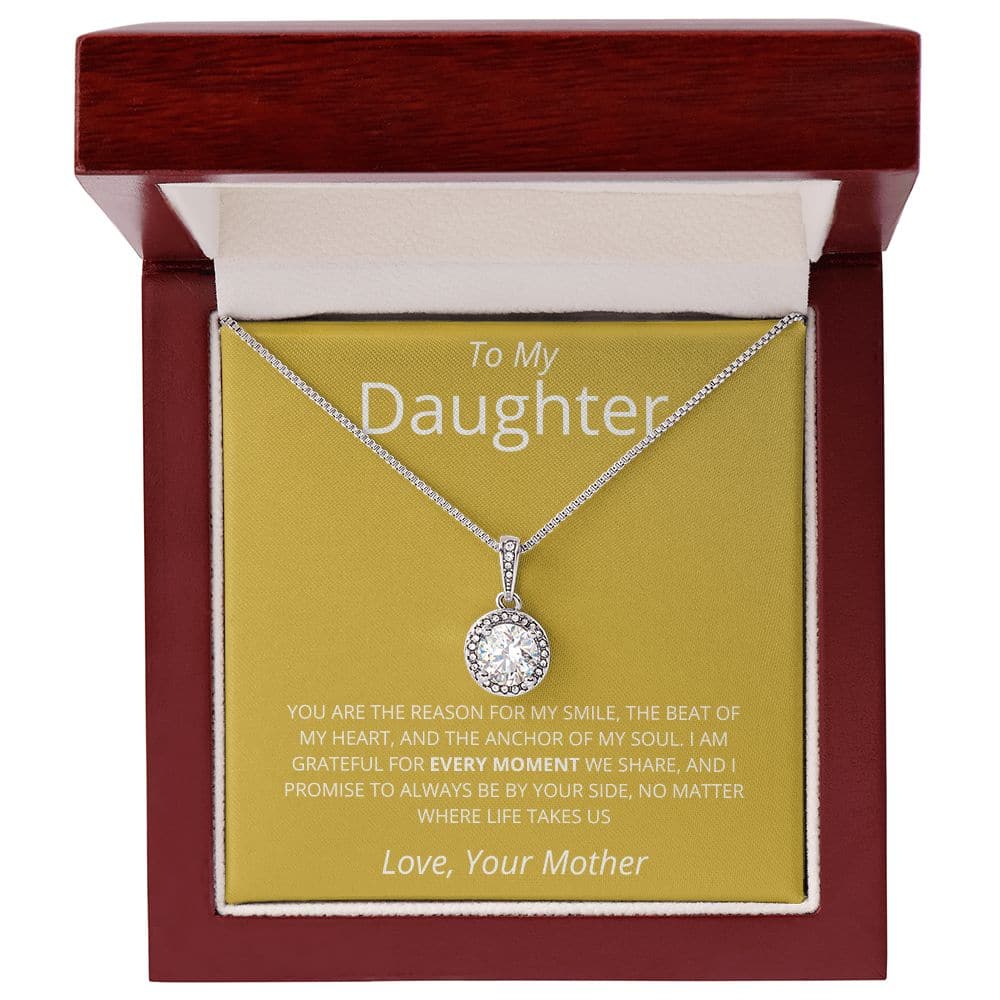 A necklace in a box, personalized for a daughter. The Golden Embrace Necklace symbolizes an unbreakable bond, adorned with a shimmering pendant. A heartfelt gift of love from a mother to her precious jewel.