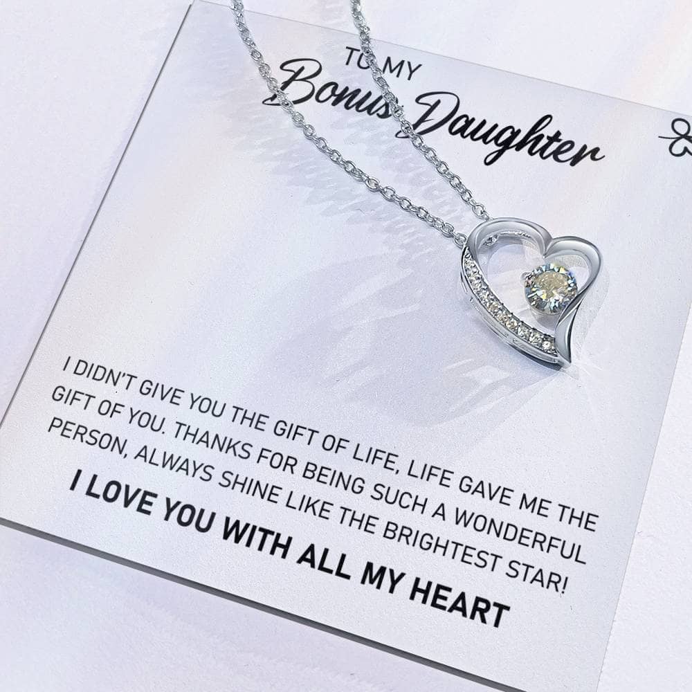 A close-up of a heart-shaped necklace on a card, the "To My Daughter" Personalized Daughter Necklace - For Unbreakable Parent-Daughter Bonds.