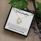 A necklace with a heart pendant in a box and a plant, part of the "To My Daughter" Personalized Necklace range by Bespoke Necklaces.