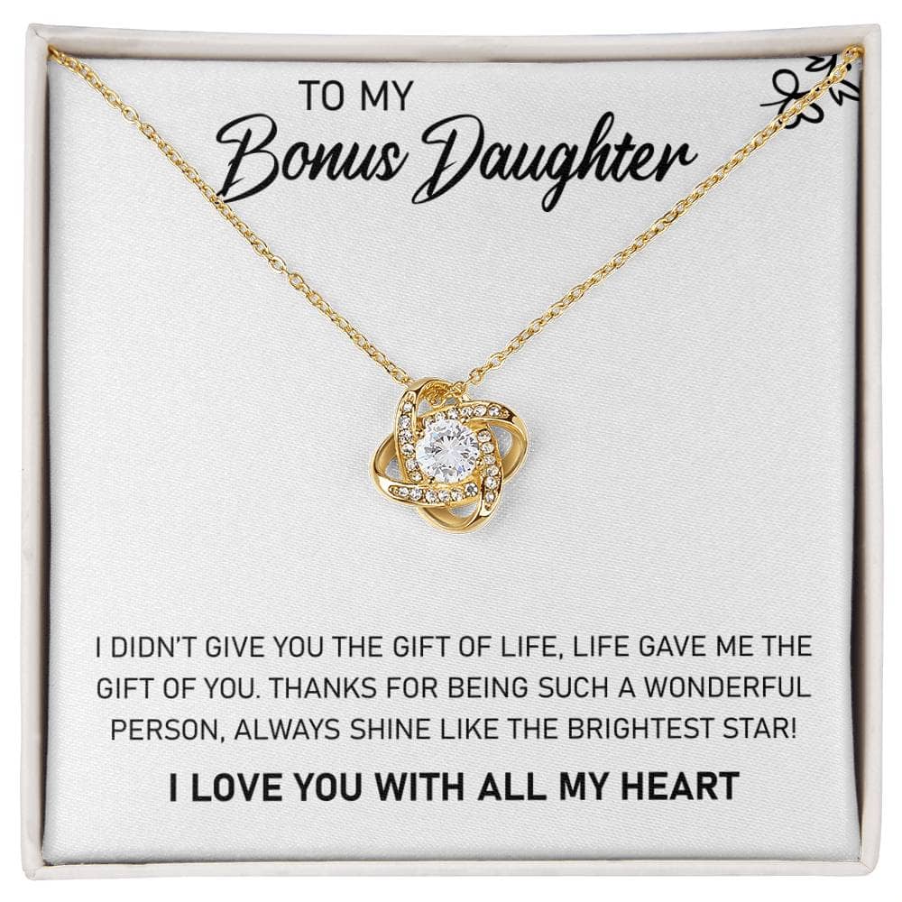 A close-up of a personalized daughter necklace with a heart-shaped pendant and a radiant cushion-cut cubic zirconia. Encased in an elegant mahogany-themed box with LED illumination.