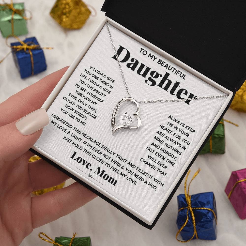 Alt text: "A hand holding a Personalized Daughter Necklace in a box, symbolizing unbreakable bonds and everlasting love."
