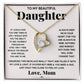 A necklace with a heart pendant in a box, symbolizing the unbreakable bond between parents and daughters.