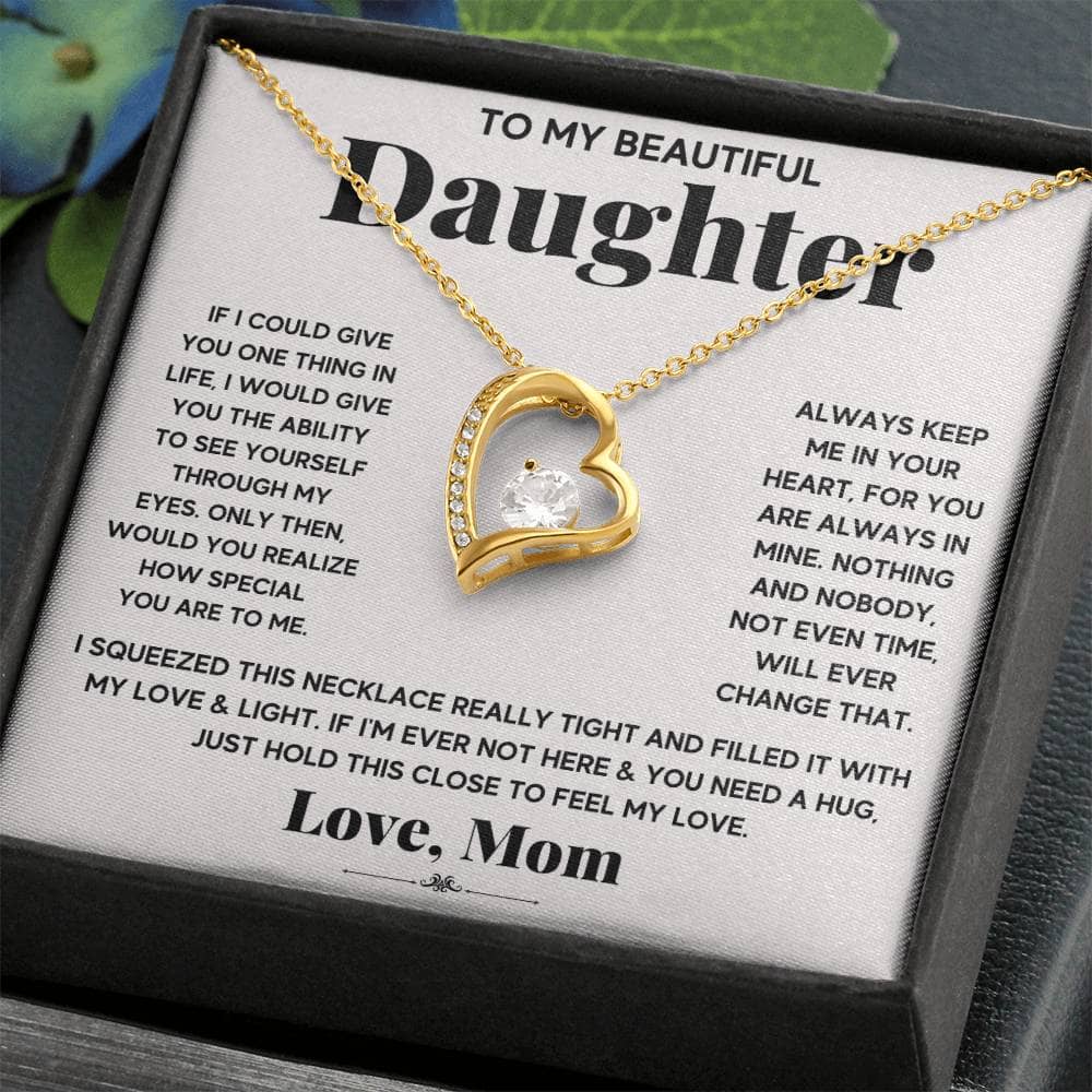 Image alt text: "Personalized Daughter Necklace: Loving Embrace - A necklace with a heart pendant in a box, symbolizing the unbreakable bond between parents and daughters."