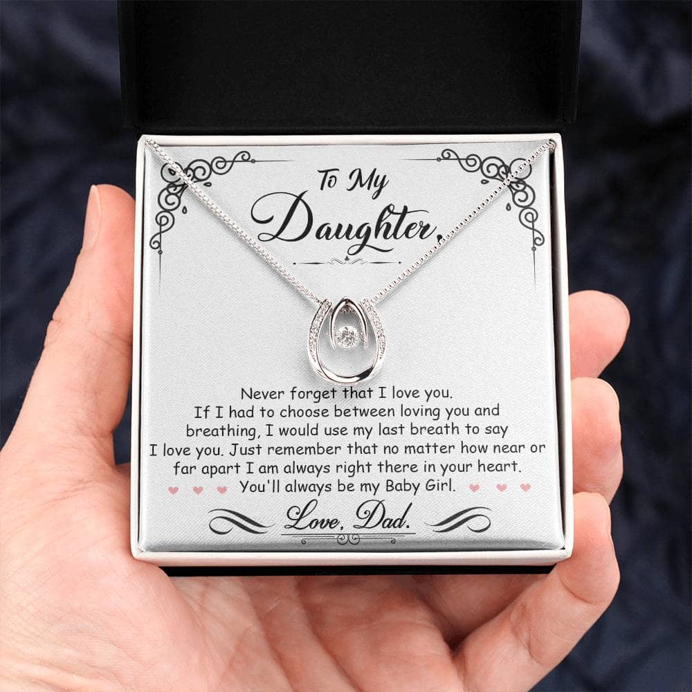 Alt text: "Personalized Daughter Necklace: Hand holding necklace in box, symbolizing the unbreakable bond between parents and daughters."
