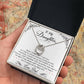 Alt text: "Personalized Daughter Necklace: Hand holding heart-shaped pendant with cubic zirconia in a box"