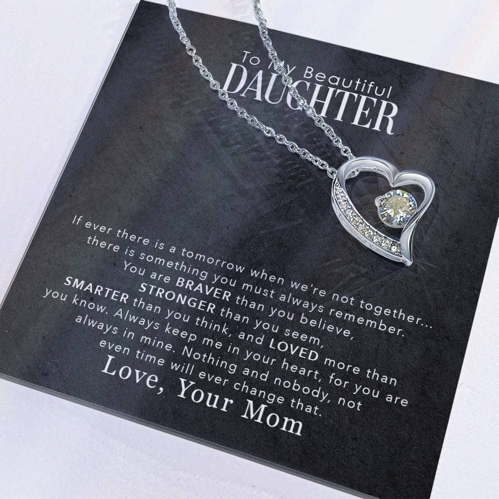 Alt text: "Close-up of heart-shaped Personalized Daughter Necklace on black card"